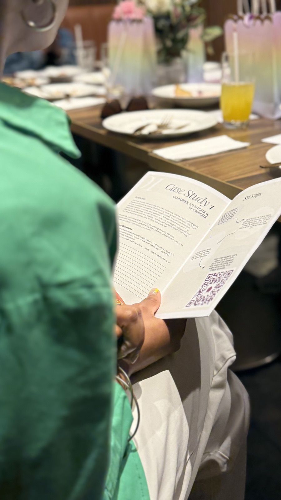 Attendee working through a Success With Steph case study booklet at a workshop