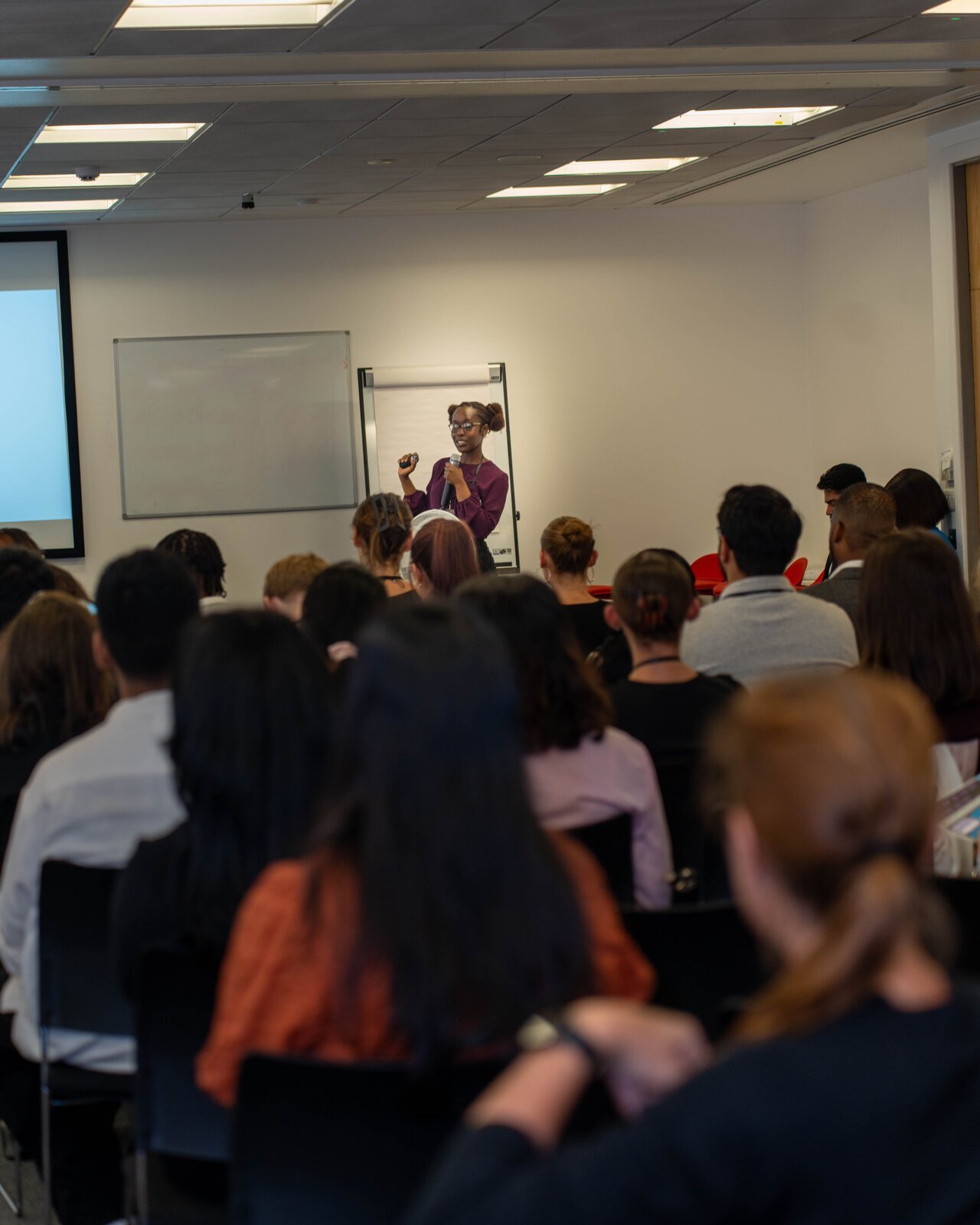 Steph speaking to a full room at a corporate career event